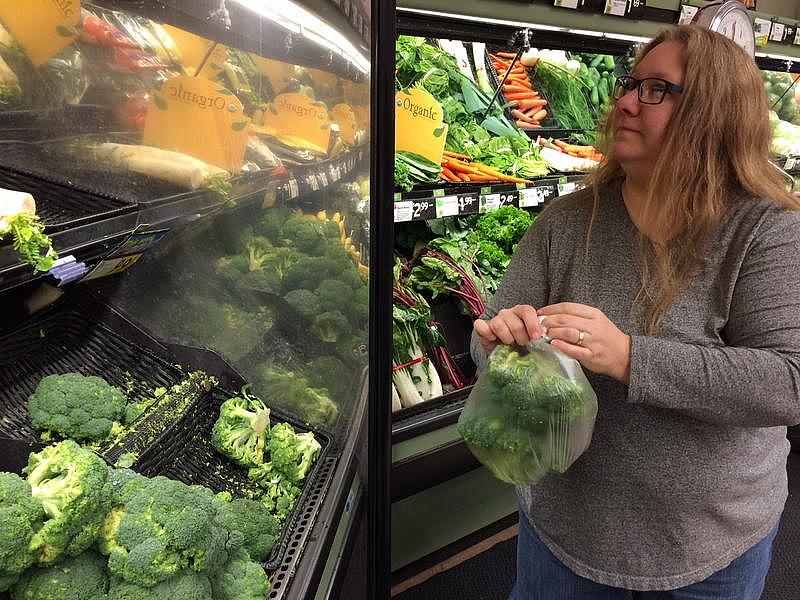 Tiffany Krastins shops for produce.