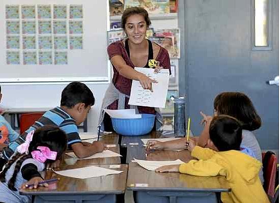 Aimee Carraczo works with first grade students in Dixon Unified Migrant Education program recently at Anderson Elementary School. Carrazco, a student teacher with the organization California Mini Corps, is spending her summer working with children of migrant workers in Dixon. Joel Rosenbaum — The Reporter