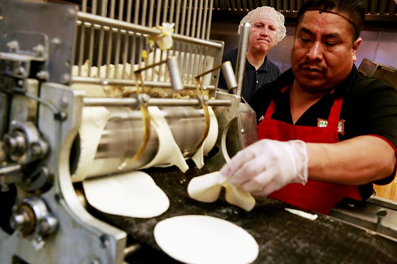 Brigham Young University professor Michael Dunn, left, works with Rancho Markets’ Jorge Morales to make tortillas fortified with folic acid in Provo, Utah. Dunn is conducting experiments that could lead the Food and Drug Administration to allow fortification of corn masa — a staple grain in Hispanic diets — with folic acid to prevent birth defects. (Erika Schultz / The Seattle Times)