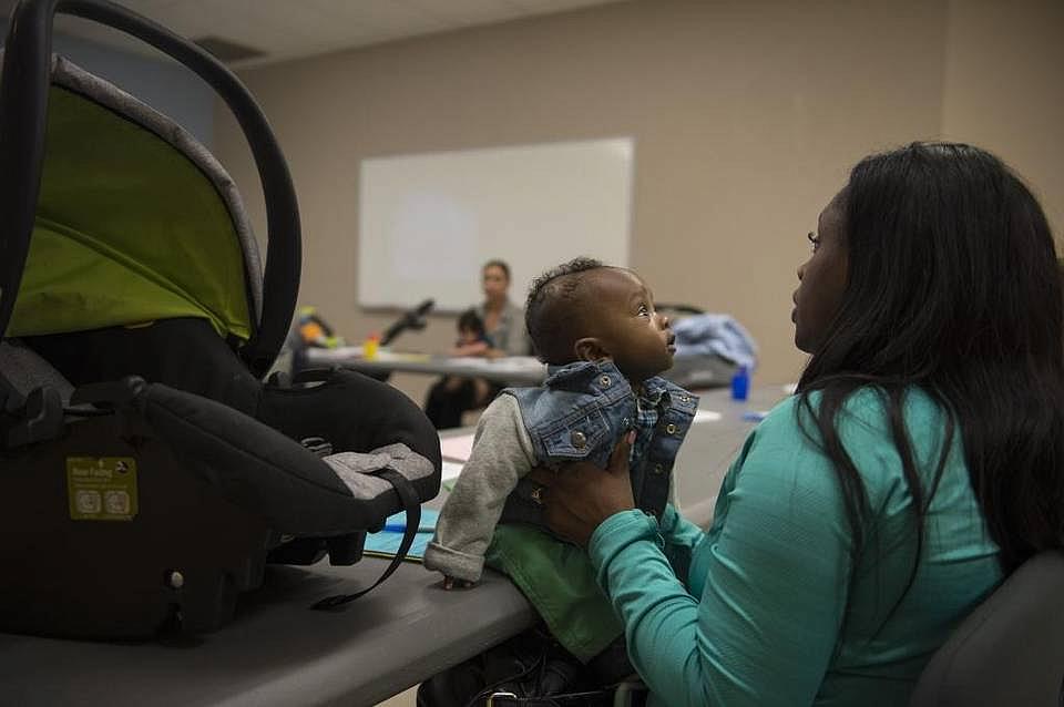 Robin Evans holds her 5-month-old son, Mekhi, during a safe-sleeping workshop in Meadowview. 