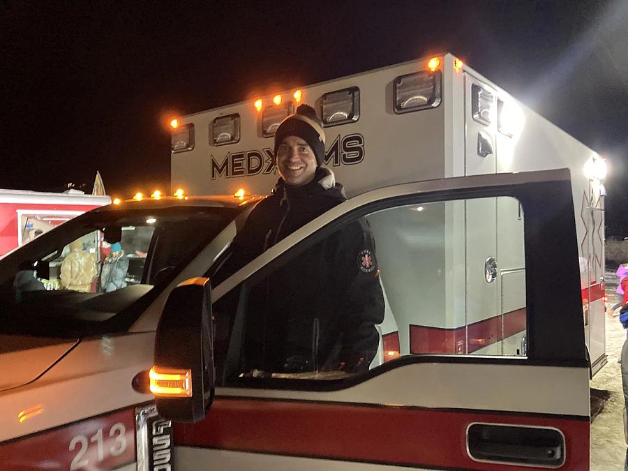 Image of a person posing for a photo at the gate of emergency vehicle