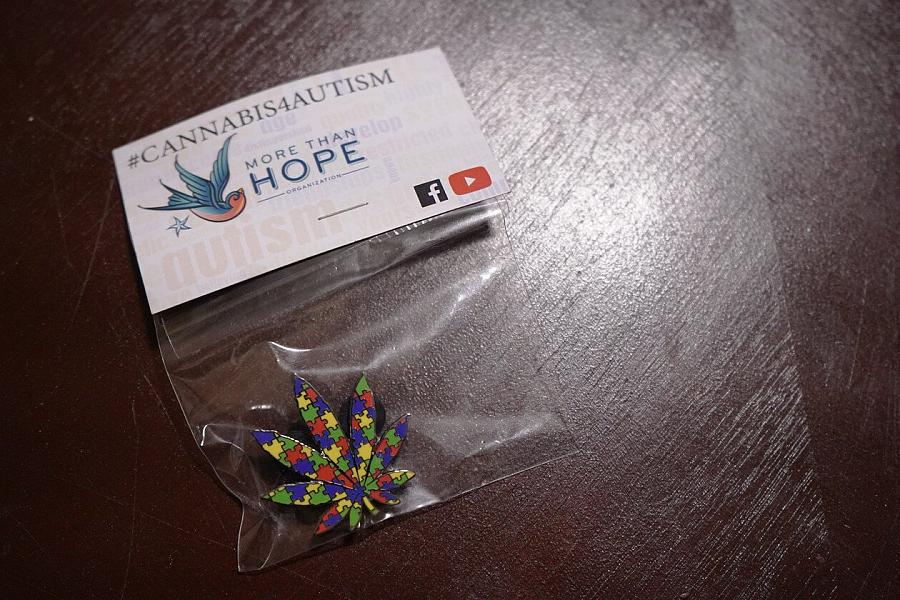 A pin designed to bring awareness to the use of cannabis to treat some symptoms of autism, which was added to the list of qualifying medical marijuana conditions under Michigan state law in 2018. | Natalie Fertig/POLITICO