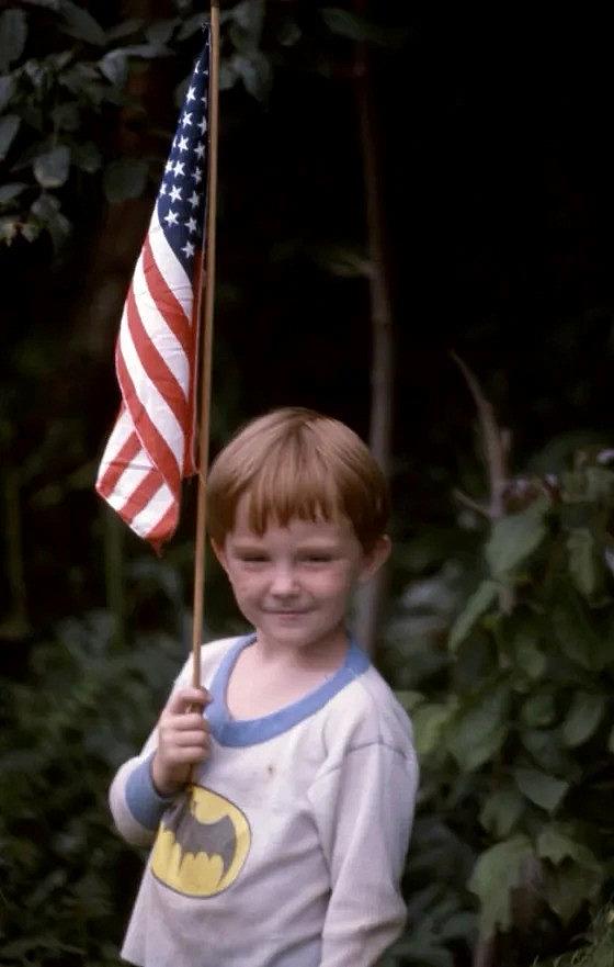 Image of child holding flag of the U.S