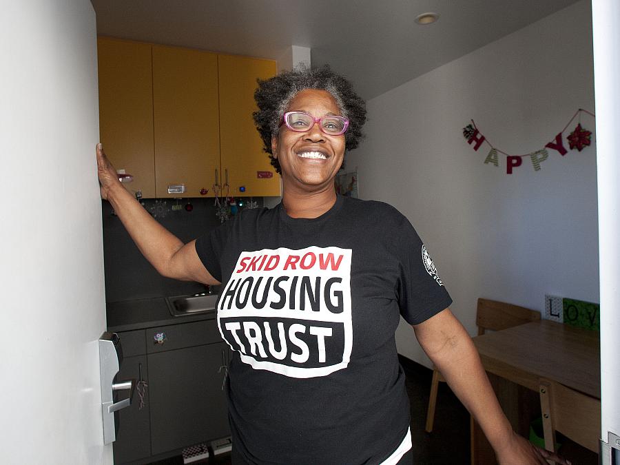 Evelyn Hilliard, formerly homeless on skid row, greets visitors at her studio in Star Apartments.