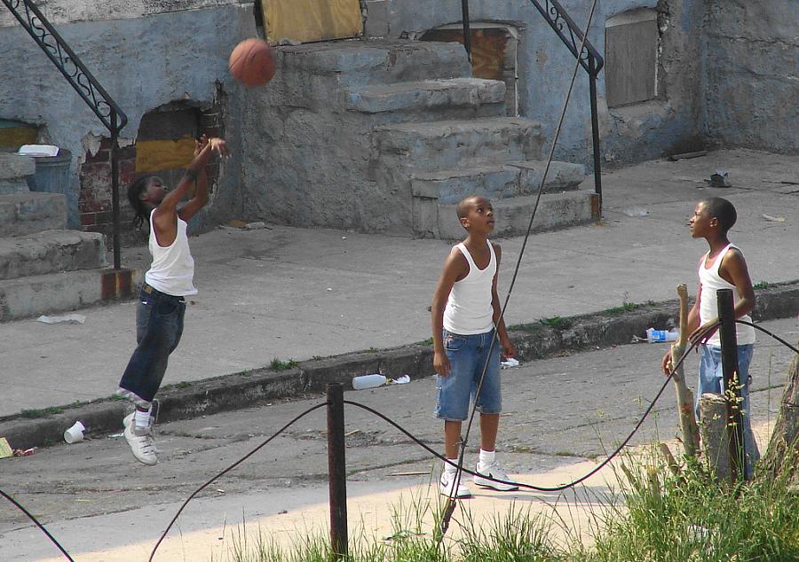 Kids playing basketball on a Baltimore street.