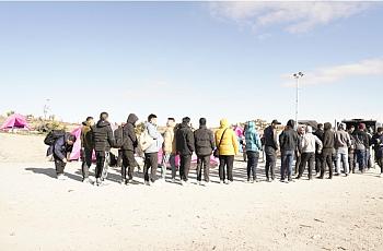 Image of people standing in a queue