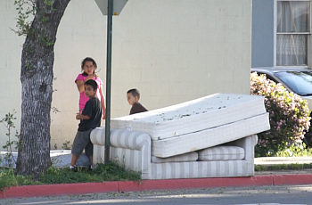 Children play on a street corner in central Santa Ana.