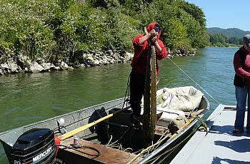 A member of the Yurok tribe pulls in a sturgeon on the Klamath River.