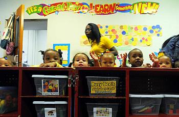 Lloyd Fox / Baltimore Sun Children wait for their next activity at Little Flowers Child Development Center. Located in the Upton/Druid Heights neighborhood, many of the children at Little Flowers are exposed to a variety of stressors, whether inside or outside the home, including violence.