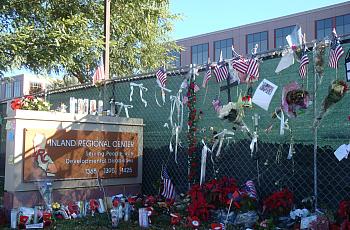 Tributes and holiday decorations adorned the wall surrounding the Inland Regional Center.