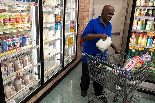 A customer buys a gallon of milk in the Cash Saver grocery store on Wilson Avenue. Sept. 25, 2018 A customer buys a gallon of milk in the Cash Saver grocery store on Wilson Avenue. Sept. 25, 2018