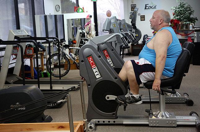 Ron Correll does physical therapy for his knee after ACL surgery, on a exercise bike at Dublin Physical Therapy on Dec. 18, 2014. (Jim Stevens/Bay Area News Group)