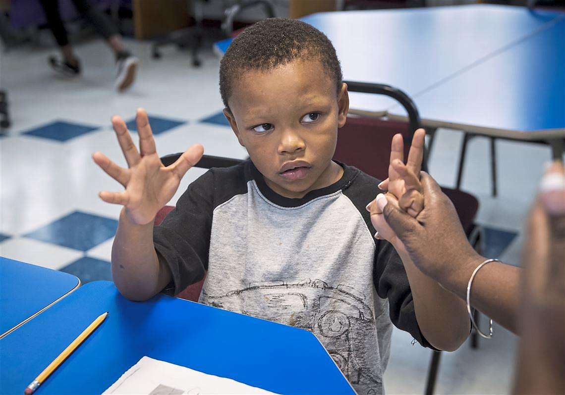 Darnell Stevens gets help with his math homework after school.