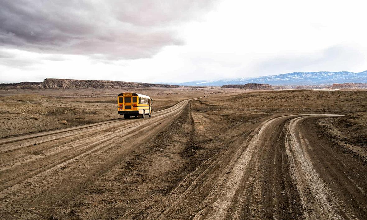 A school bus on the unpaved Indian service route 5010 near Sanostee. The seven-mile corridor connects as many as 2,500 residents to the outside world – or denies them access altogether. A school bus on the unpaved Indian service route 5010 near Sanostee. The seven-mile corridor connects as many as 2,500 resident