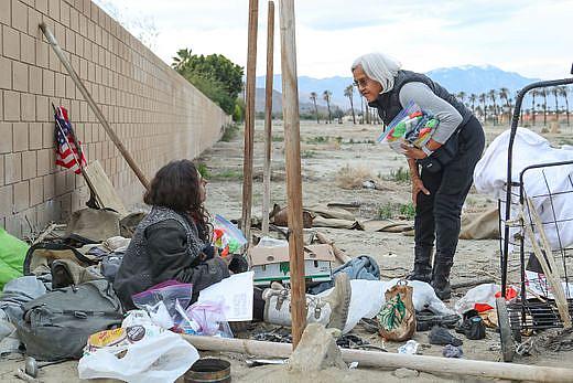 Terry Ramon, right, talks with a young homeless woman in Indio.