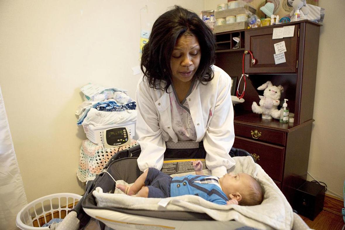 Flossie Horace takes oxygen levels and weighs her 3-month-old grandson every morning in her Roanoke home. Flossie Horace takes oxygen levels and weighs her 3-month-old grandson every morning in her Roanoke home.
