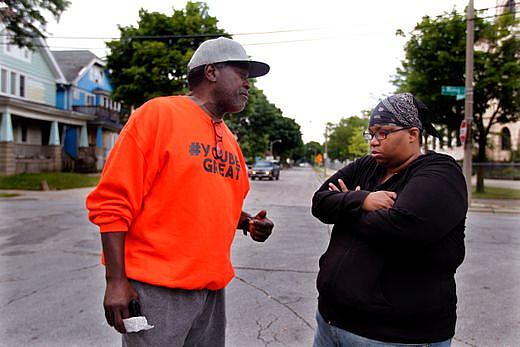 Andre Lee Ellis, left, talks with Lisa Huston, right, who escorted her son to the "We Got This" summer program. Ellis was thanki