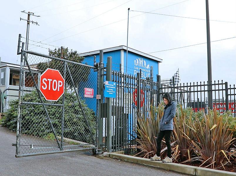 Heather Lee stands outside a closed gate at the Public Works yard after attempting to reclaim her belongings. Heather Lee stands outside a closed gate at the Public Works yard after attempting to reclaim her belongings.