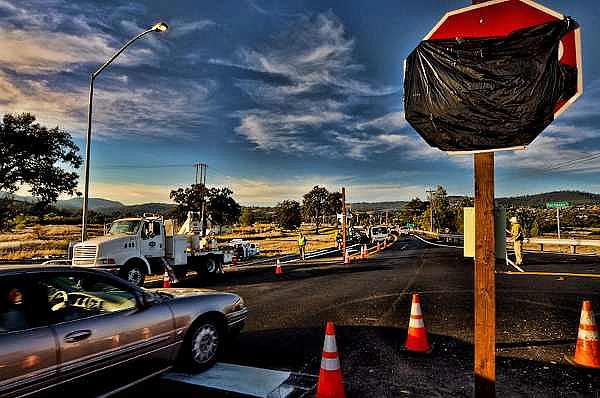 Caltrans workers installed three-way stop signs at the intersection of Hartmann Road and Highway 29 near Middletown, Calif., on 