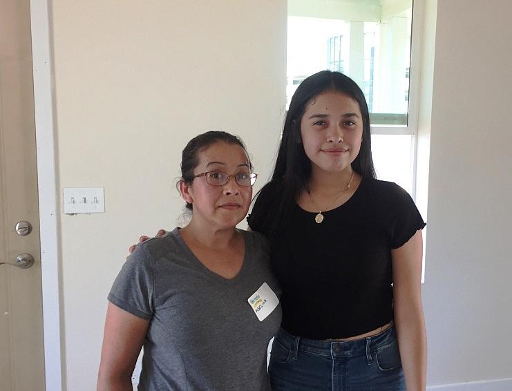 Miranda Hernandez and her mom, Adelina, stand inside their new home.