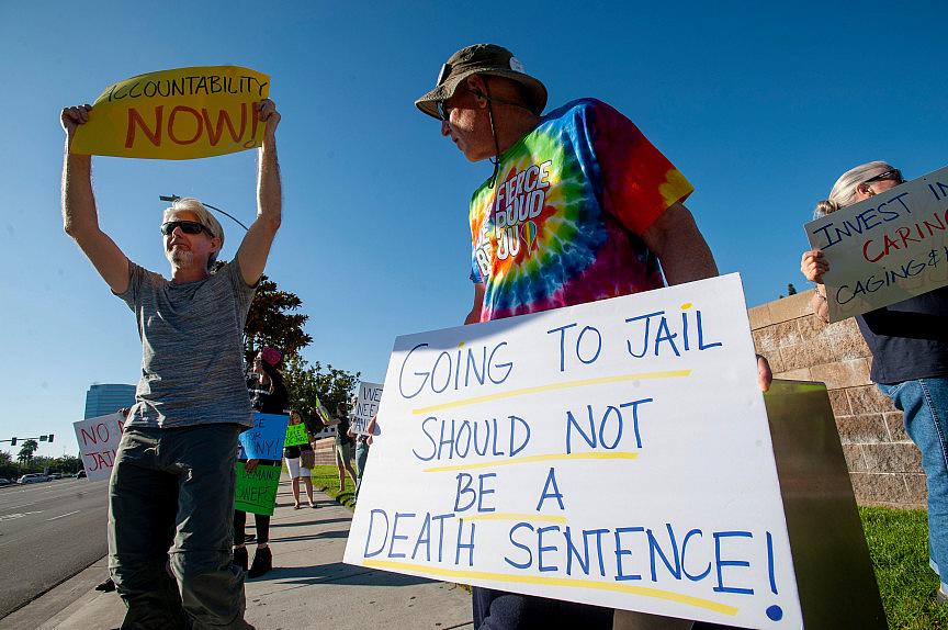 Andy Lewandowski, center, of Anaheim takes part in a rally outside the Theo Lacy Facility in Orange on Saturday, July 20, 2019 to protest jail deaths. Andy Lewandowski, center, of Anaheim takes part in a rally outside the Theo Lacy Facility in Orange on Saturday, July 20, 2019 t