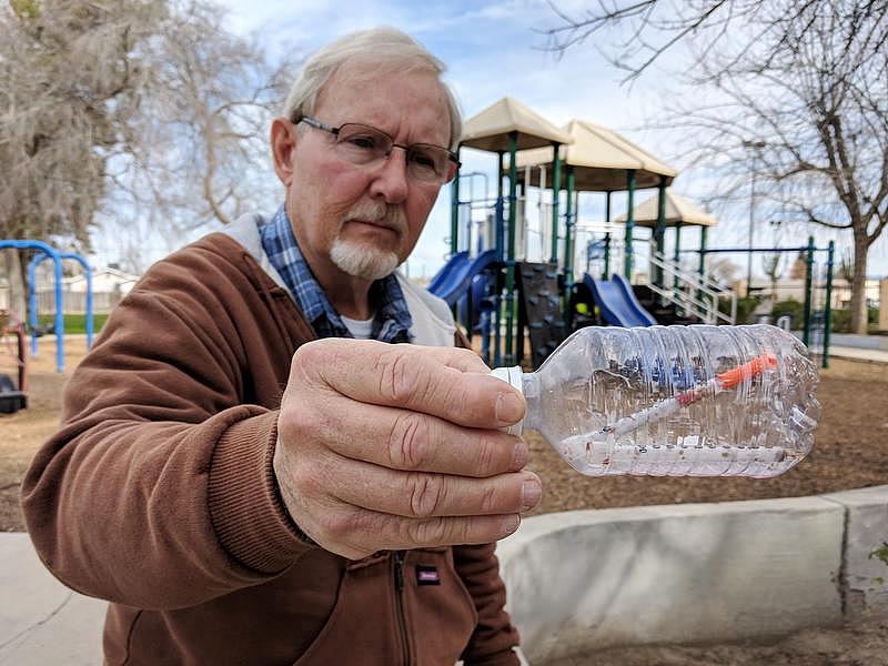 Oildale Community Action Team director Dave Kadel stands with a hypodermic needle he found.