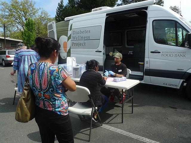 Morgan Smith, a registered nurse with the Redwood Empire Food Bank Diabetes Wellness Project, conducts free diabetes screenings once a month at the Graton Day Labor Center. The center serves as a conduit between its members — many of whom are undocumented — and health organizations around the region. (Lisa Morehouse/KQED)