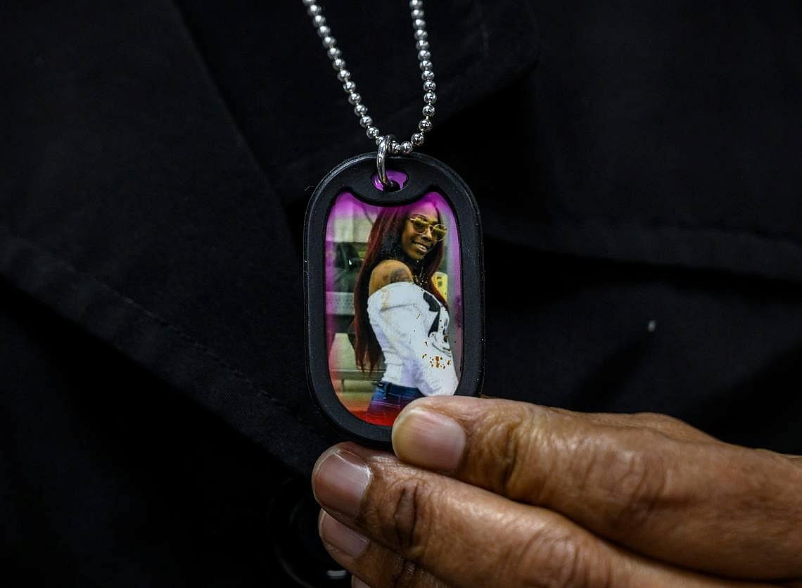 Lorrie Johnson wears a necklace with a picture of her late granddaughter Dajha Richards.