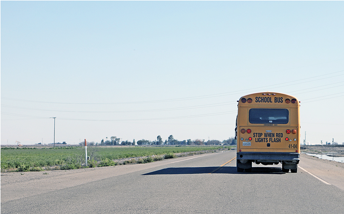 A rural school bus heads out to a campus to pick up students. A rural school bus heads out to a campus to pick up students.