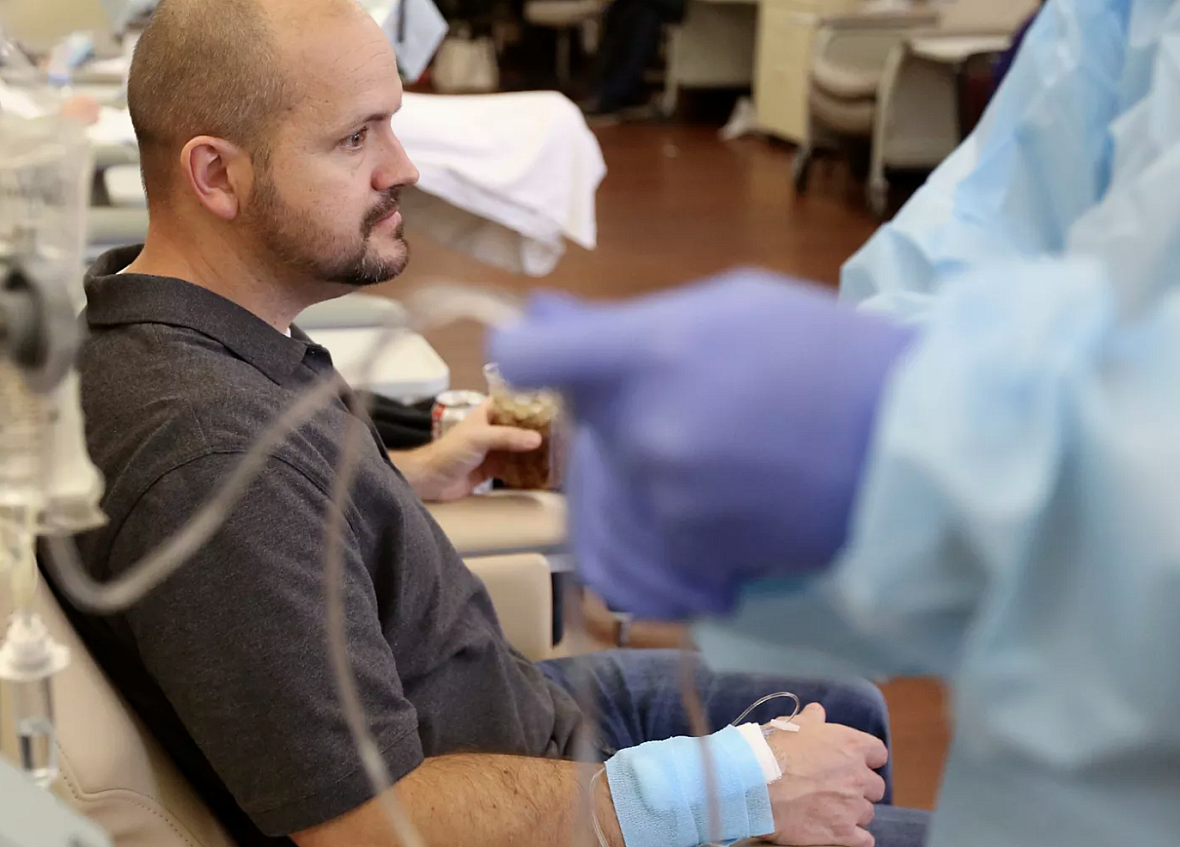 Dustin Wallis, a 39-year-old nonsmoker, receives an infusion to treat stage 4 lung cancer at Utah Cancer Specialists.