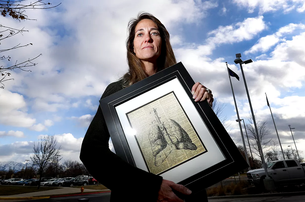 Eleanor Divver, radon project manager for the Utah Department of Environmental Quality, holds a favorite illustration of lungs.