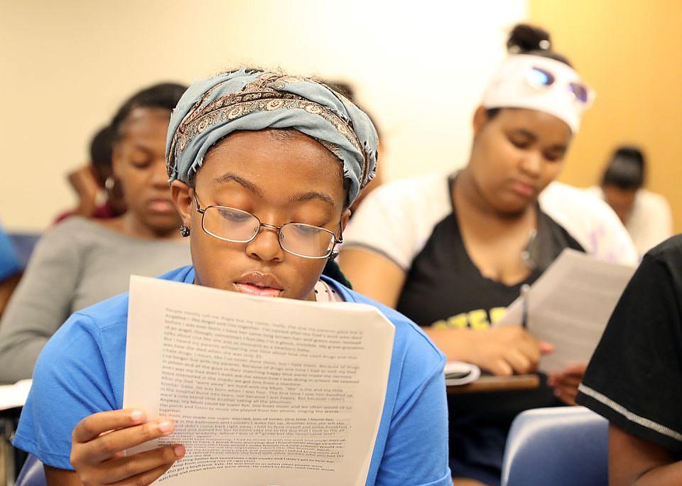 Cailah Porter, 15, reads over an example of a short story.