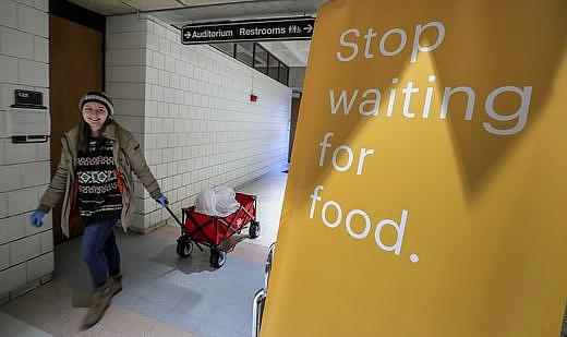 Henny Ransdell pulls a wagon carrying Einstein Bros. Bagels in the Bingham Humanities Building on UofL's campus. The bagels, donated by the business, were then taken to the university's food bank that has just opened. Henny Ransdell pulls a wagon carrying Einstein Bros. Bagels in the Bingham Humanities Building on UofL's campus. The bagels, don