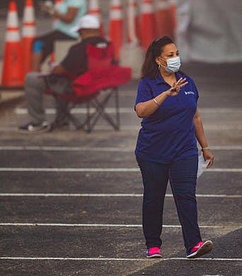 Dr. Temple Robinson, CEO of Bond Community Health Center, asks for those who made an appointment to come forward. Dr. Temple Robinson, CEO of Bond Community Health Center, asks for those who made an appointment to come forward.