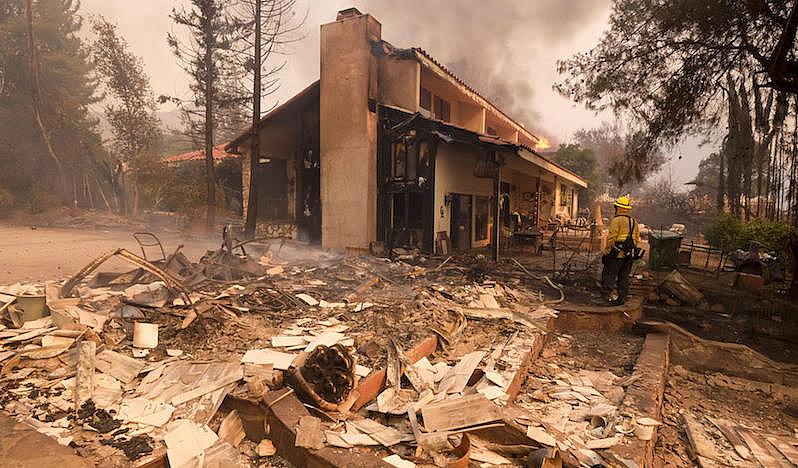 A firefighter keeps watch during the Woolsey Fire in Malibu, California on Nov. 9, 2018.