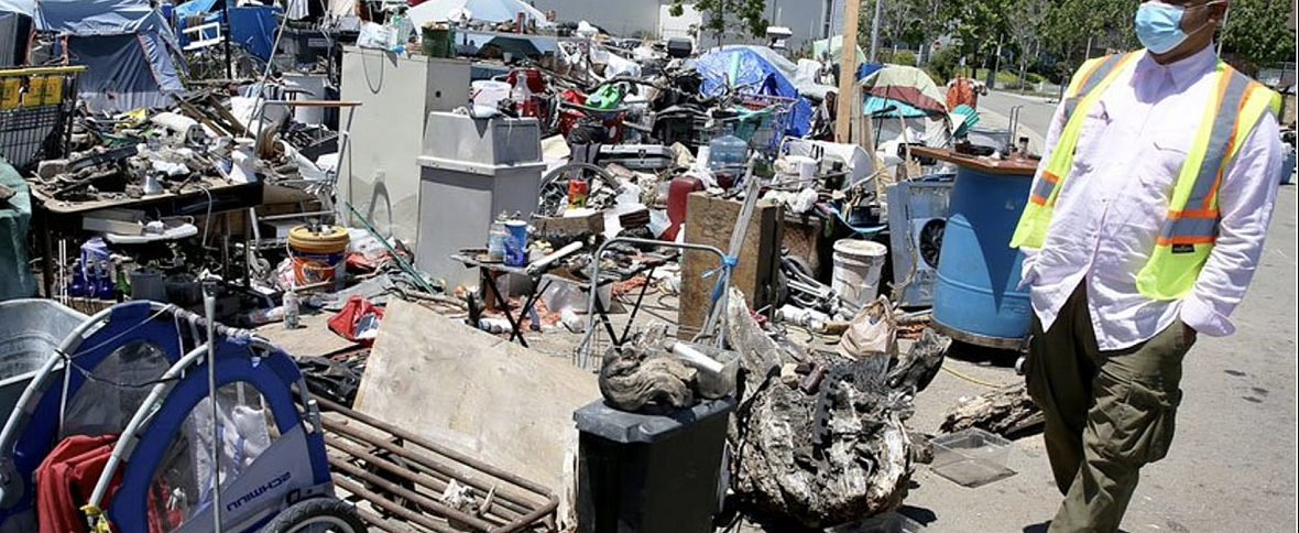 Preston Turner walks through a homeless encampment at Union Point in Oakland, Calif., on Wednesday, May 27, 2020. The city of Oakland is trying to get coronavirus testing for homeless people. Preston Turner walks through a homeless encampment at Union Point in Oakland, Calif., on Wednesday, May 27, 2020. The city of Oa