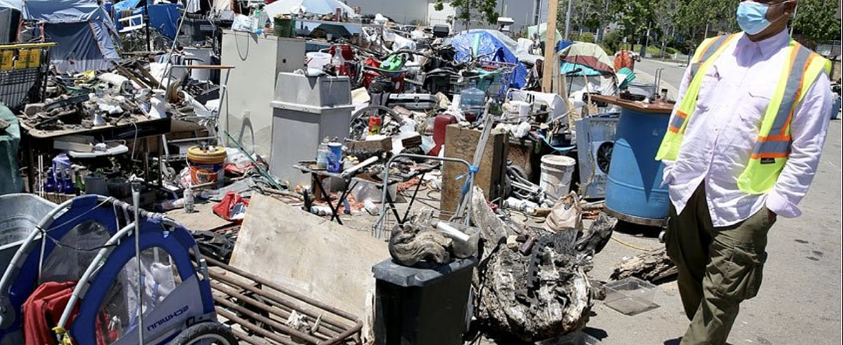 Preston Turner walks through a homeless encampment at Union Point in Oakland, Calif., on Wednesday, May 27, 2020. The city of Oa