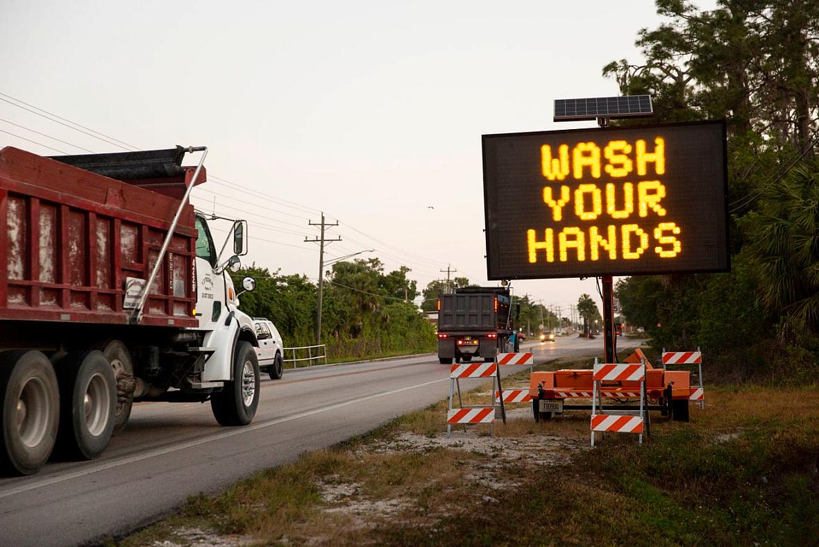 A sign along Immokalee Road encourages people to wash their hands and stay six feet apart to limit the spread of coronavirus in 
