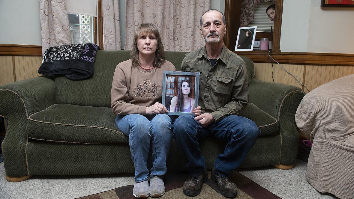 Kay and Jon Steigerwalt sit in the living room of her Palmerton home, holding a photograph of their daughter Deanna. Deanna died