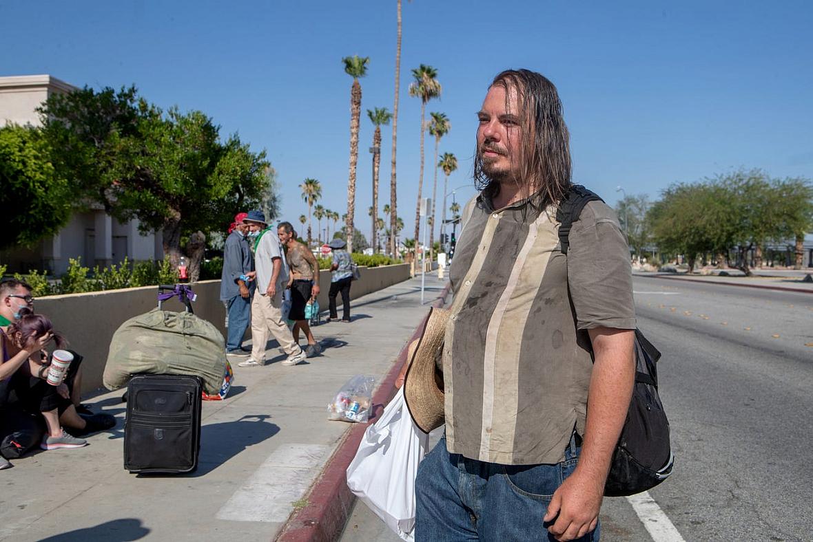 Janos Szilagyi, 39, right, waits across the street before the emergency overnight shelter run by the Coachella Valley Rescue Mission inside a portion of the Palm Springs High School Gymnasium on Saturday , June 27, 2020. Taya Gray, Taya Gray Janos Szilagyi, 39, right, waits across the street before the emergency overnight shelter run by the Coachella Valley Rescue M