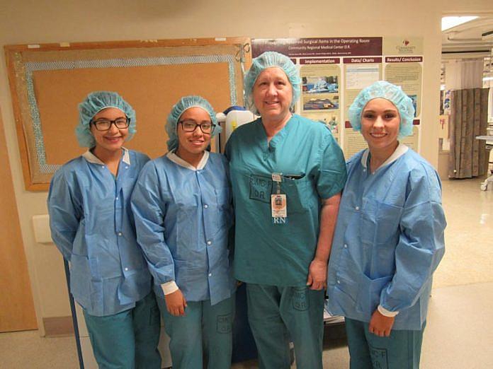 Doctors Academy students Yesenia Avina, Jennifer Becerra and Alexandra Snyder during a field visit with Debora Redondo, RN, BSN.