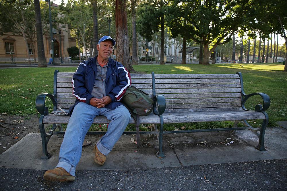 A man named Roberto sits on a bench at St. James Park in San Jose, Calif., on June 7, 2016