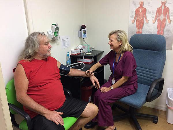 Kim Harden takes a patient's blood pressure at the Lake Wales Free Clinic. Julio Ochoa/WUSF Kim Harden takes a patient's blood pressure at the Lake Wales Free Clinic. Julio Ochoa/WUSF