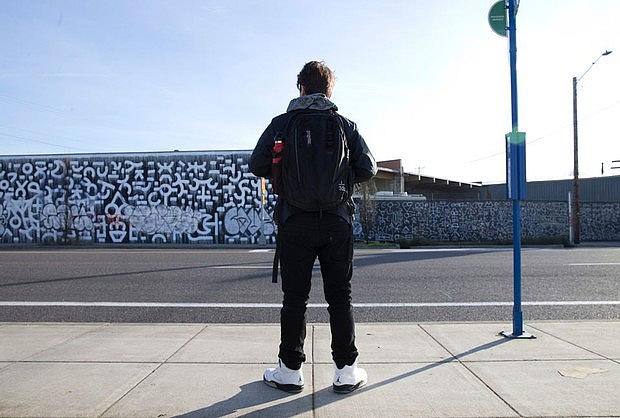 Frankie Serrano waits for a bus. It's one leg of a long journey he does every morning to stay in his school. Frankie Serrano waits for a bus. It's one leg of a long journey he does every morning to stay in his school.