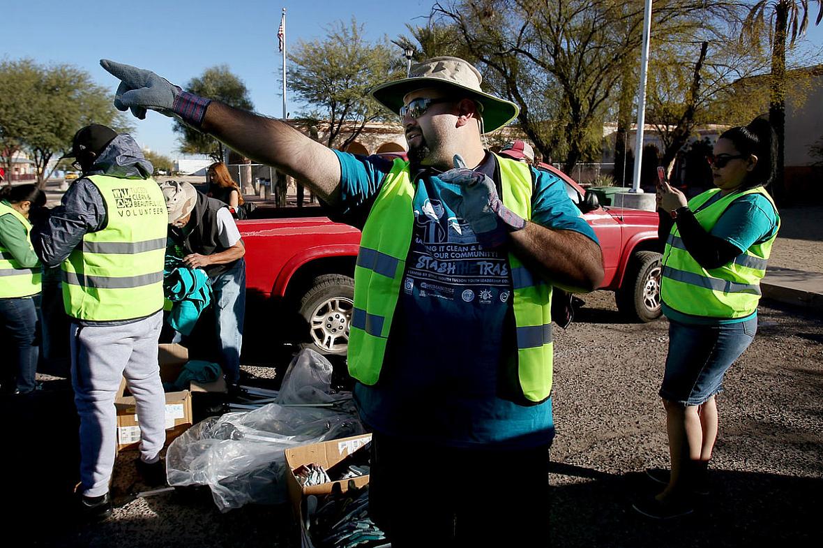 Lorenzo Gonzalez, head of the Healthy South Tucson Coalition, directs a trash cleanup on South Sixth Avenue, an area of concentrated poverty and home to many children of immigrant parents. Photos by Mike Christy / Arizona Daily Star Photos by Mike Christy / Arizona Daily Star