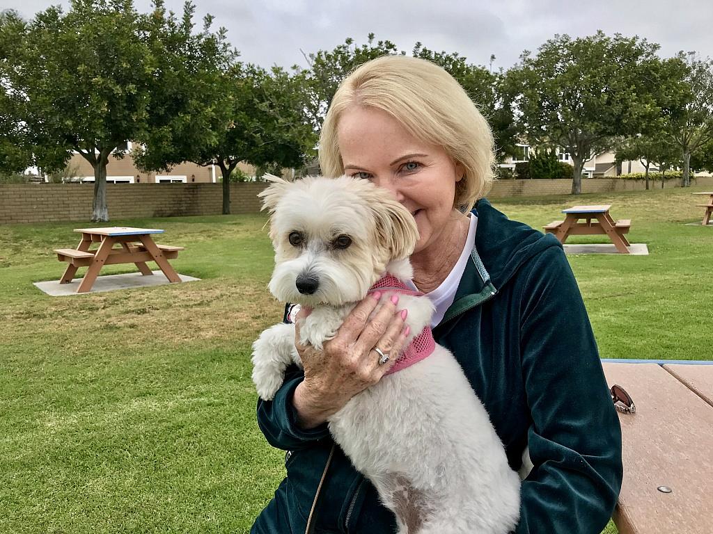 Jan Curtis and her dog, Belle, at a park near her Huntington Beach home on April 27, 2018. Curtis hopes she's nearing the end of a decades-long struggle with chronic pain and the opioid dependence that came with it. Jill Replogle Jill Replogle