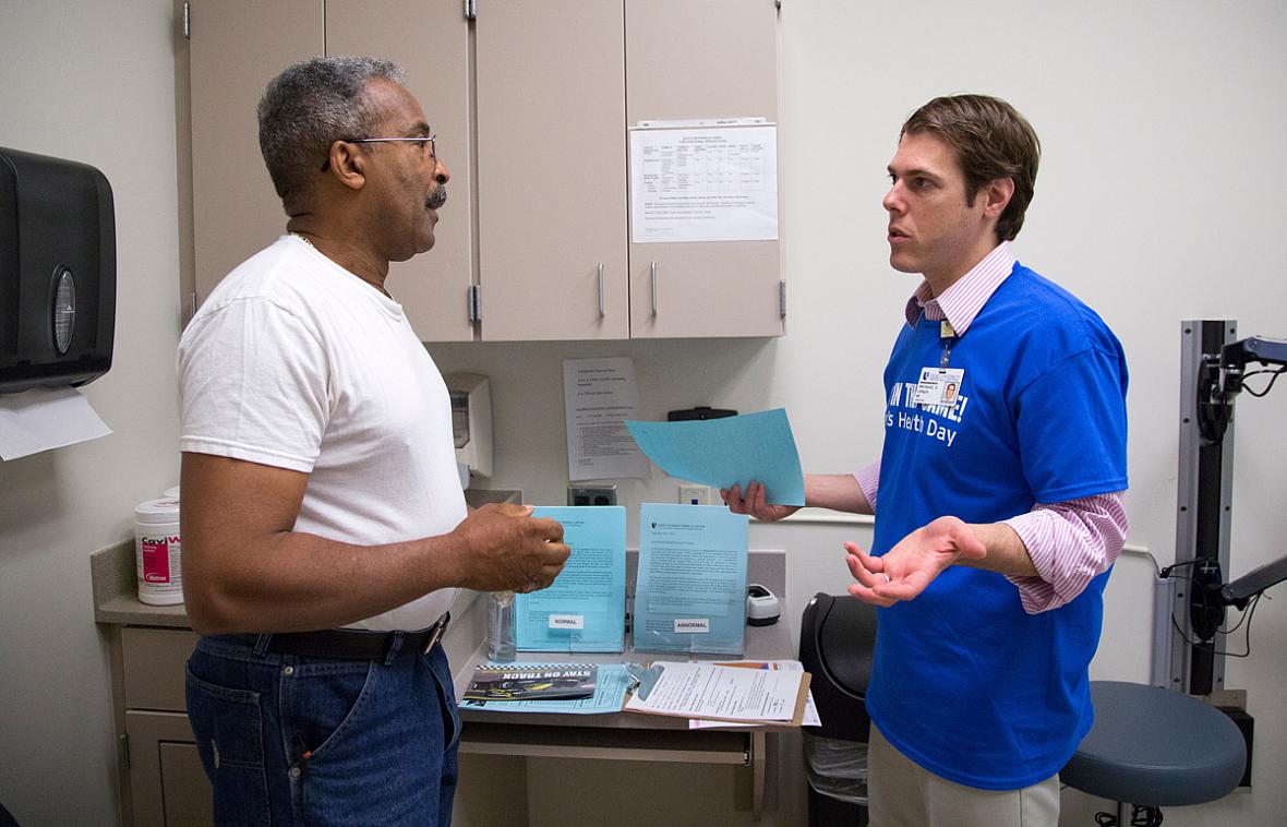 SHAWN ROCCO / DUKE MEDICINE PHOTOGRAPHY William Thorpe, 64, left, speaks with Dr. Michael Lipkin, a urology specialist from Duke, after a prostate examination during the Mens' Health Day at Lincoln Community Health Center in Durham in September 2014.