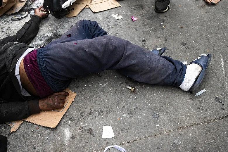 An image of a person passed out in the alley