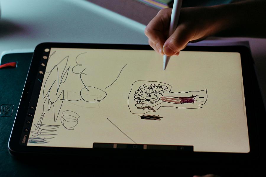 A child draws on a sketch pad.