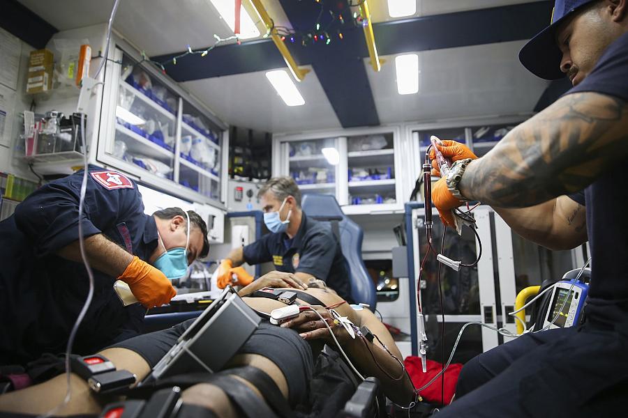 Image of paramedics helping a victim